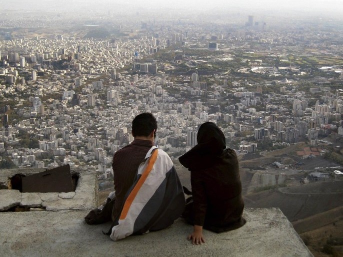 An Iranian couple sit overlooking the city of Tehran, in this October 19, 2006 file photo. The divorce rate in Iran is soaring. Since 2006, the rate of divorce has increased more than one a half times to the point where around 20 percent of marriages now end in divorce. In the first two months of this Iranian calendar year (late March to late May 2014) alone, more than 21,000 divorce cases were logged, according to official statistics. The rise in the number of couples