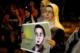 The mother of the hunger-striking Palestinian prisoner Bilal Kayed holds his picture during a protest in favour of his release, at Barzilai Hospital in the southern Israeli city of Ashkelon August 9, 2016 REUTERS/Amir Cohen