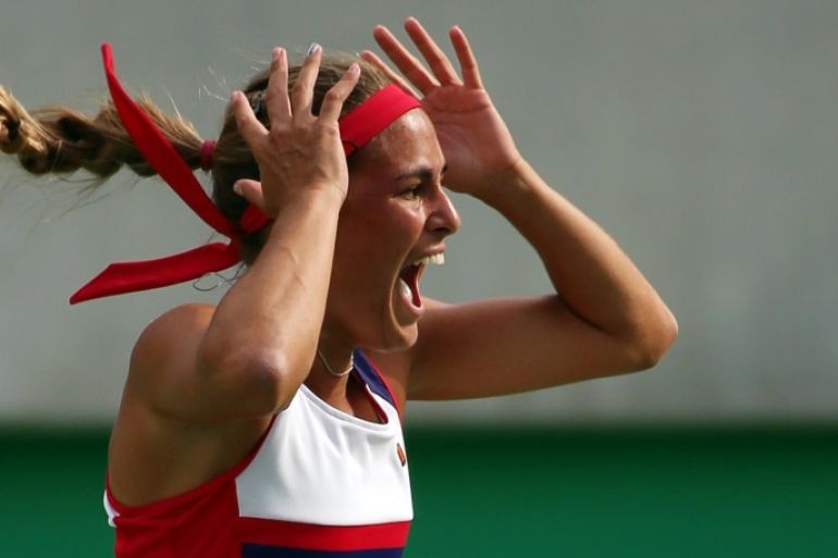 2016 Rio Olympics - Tennis - Semifinal - Women's Singles Semifinals - Olympic Tennis Centre - Rio de Janeiro, Brazil - 12/08/2016. Monica Puig (PUR) of Puerto Rico celebrates after winning her match against Petra Kvitova (CZE) of Czech Republic. REUTERS/Kevin Lamarque TPX IMAGES OF THE DAY. FOR EDITORIAL USE ONLY. NOT FOR SALE FOR MARKETING OR ADVERTISING CAMPAIGNS.