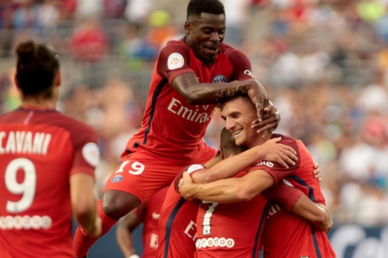 Paris Saint-Germain player Serge Aurier (C) congratulates Thomas Meunier (R) after he scored a goal against Real Madrid during the International Champions Cup match between Real Madrid and Paris Saint-Germain at the Ohio Stadium in Columbus, Ohio, USA, 27 July 2016.