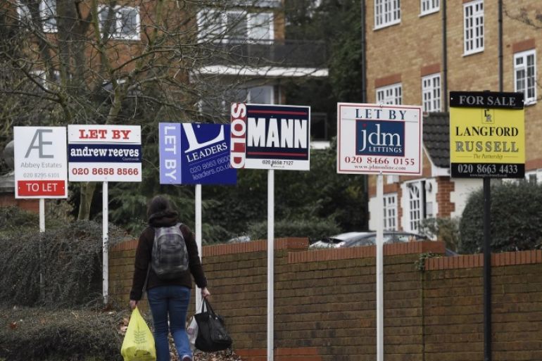 A woman walks past by 'To Let' or 'Sold' signs in south-east London, Britain, 31 January 2016. House prices have rocketed in the outskirts of the capital as buyers move further out. The housing property market has seen rises up the 20 per cent such in the boroughs of Newham or Waltham Forest in the last year alone, while boroughs such as Westminster had a very modest increase.