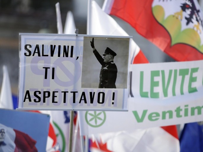 A placard reading "Salvini, expecting you," with a picture of Italian wartime dictator Benito Mussolini, is held up at a rally held by Northern League party leader Matteo Salvini in Rome, February 28, 2015. REUTERS/Max Rossi (ITALY - Tags: POLITICS CIVIL UNREST)
