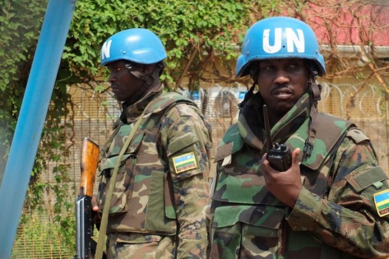 Rwandan peacekeepers serving in the United Nations Mission in South Sudan (UNMISS) stand guard inside their compound as members of the civil society and political parties participate in a protest against foreign military deployment to South Sudan in the capital Juba, July 20, 2016. REUTERS/Stringer FOR EDITORIAL USE ONLY. NO RESALES. NO ARCHIVES.