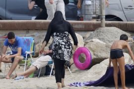 A Muslim woman wears a burkini, a swimsuit that leaves only the face, hands and feet exposed, on a beach in Marseille, France, August 17, 2016. REUTERS/Stringer