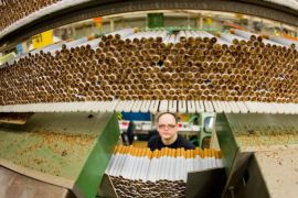 (FILE) A file photo dated 31 October 2013 showing an employee standing behind 'West' cigarettes in the Reemtsma cigarette factory, a wholly owned subsidiary of the Imperial Tobacco Group PLC., in Langenhagen, Germany. About 700 employees in the factory produce more than 30 billion cigarettes annually, which are exported to over 100 countries. Imperial Tobacco Group PLC. released their 2016 half year results for the six months ended in March 2016 on 04 May 2016, saying