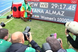 Almaz Ayana of Ethiopia poses in front of the scoreboard after winning the women's 10000m final with a new world record at the Rio 2016 Olympic Games Athletics, Track and Field events at the Olympic Stadium in Rio de Janeiro, Brazil, 12 August 2016.