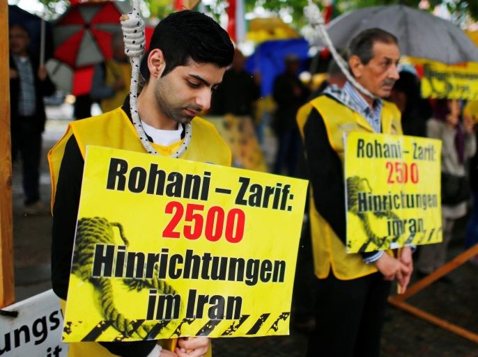 People on fake gallows protest against the visit of Iran's Foreign Minister Javad Zarif in Berlin, Germany, June 15, 2016. Sign reads: " Rohani - Zarif: 2500 executions in the Iraq". REUTERS/Hannibal Hanschke