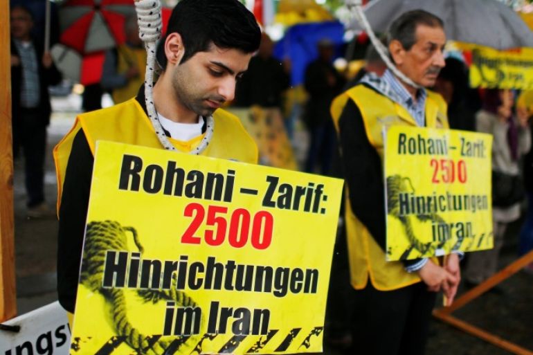 People on fake gallows protest against the visit of Iran's Foreign Minister Javad Zarif in Berlin, Germany, June 15, 2016. Sign reads: " Rohani - Zarif: 2500 executions in the Iraq". REUTERS/Hannibal Hanschke