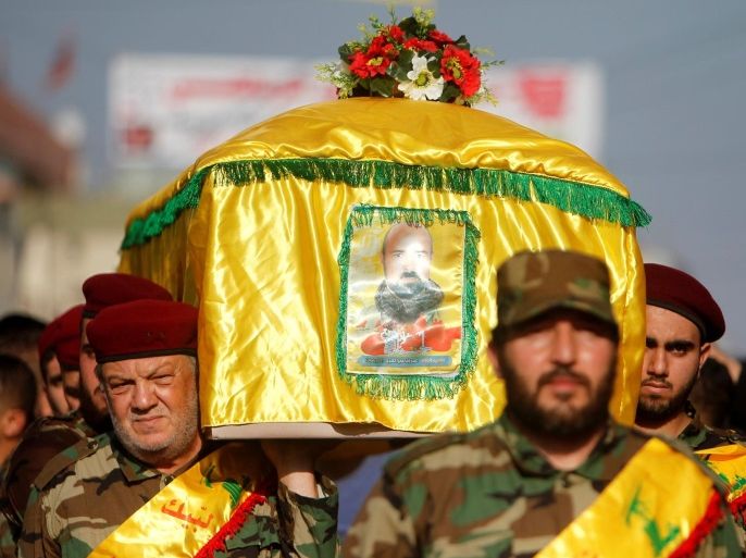 Lebanon's Hezbollah members carry the coffin of their comrade, Omar al-Obeid, who was killed fighting alongside Syrian army forces in Syria, during his funeral in Doueir village, near Nabatieh in southern Lebanon, July 5, 2016. REUTERS/Ali Hashisho
