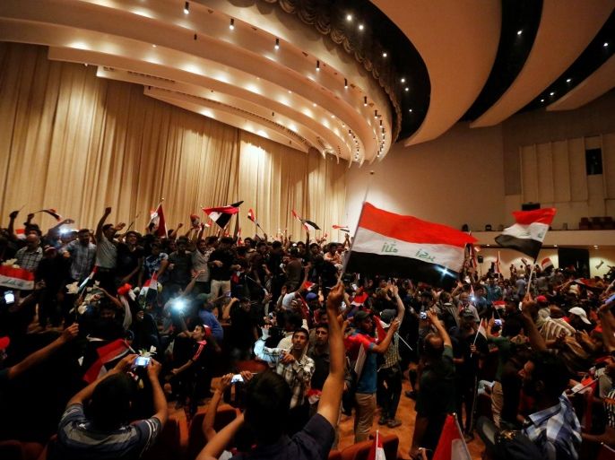 Followers of Iraq's Shi'ite cleric Moqtada al-Sadr are seen in the parliament building as they storm Baghdad's Green Zone after lawmakers failed to convene for a vote on overhauling the government, in Iraq April 30, 2016. REUTERS/Ahmed Saad