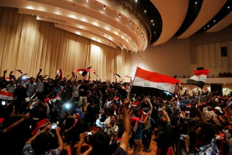 Followers of Iraq's Shi'ite cleric Moqtada al-Sadr are seen in the parliament building as they storm Baghdad's Green Zone after lawmakers failed to convene for a vote on overhauling the government, in Iraq April 30, 2016. REUTERS/Ahmed Saad