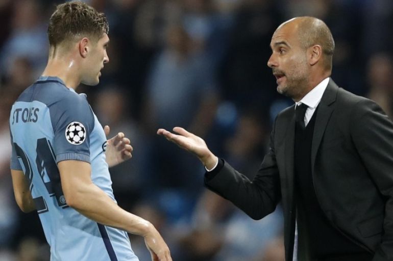 Britain Soccer Football - Manchester City v Borussia Monchengladbach - UEFA Champions League Group Stage - Group C - Etihad Stadium, Manchester, England - 14/9/16 Manchester City's John Stones with Manchester City manager Pep Guardiola Action Images via Reuters / Carl Recine Livepic EDITORIAL USE ONLY.