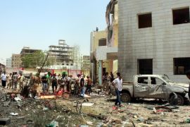 epa05513957 Yemenis inspect the site of a suicide bombing targeting a recruitment center in the southern port city of Aden, Yemen, 29 August 2016. According to reports, at least 60 people were killed by an Islamic State (IS) suicide bomber who drove an explosive car into a recruitment center run by pro-government militias in the southern Yemeni city of Aden. EPA/STR