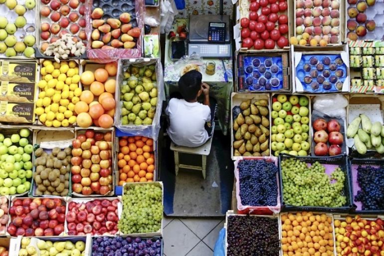 A boy takes a meal break at a fruit stall in the central market in Kazan, Russia, August 11, 2015. REUTERS/Hannibal Hanschke
