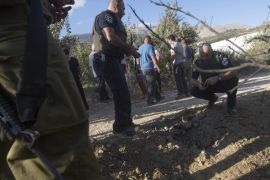 Israeli police and local Druze citizens inspect an apple plantation area hit by a projectile launched from Syria near the Druze village of Majdal Shams, northern Golan Heights, Israel, 13 September 2016. No injuries or damage were reported. An Israeli Army spokesman denied claims by the Syrian government that the Syrian army shot down an Israeli warplane and a drone over the Golan Heights overnight.