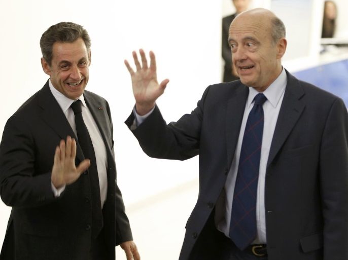 File photo of Nicolas Sarkozy (L), newly elected head of the French conservative party UMP party, who accompanies French politician Alain Juppe, former prime minister and Mayor of Bordeaux, after a meeting at the party headquarters in Paris December 3, 2014. Former president Nicolas Sarkozy has crept back into contention to become the conservative candidate in France's 2017 presidential election, overtaking Juppe among core supporters of their Les Republicains party. PIcture taken December 3, 2014. REUTERS/Charles Platiau/File Photo