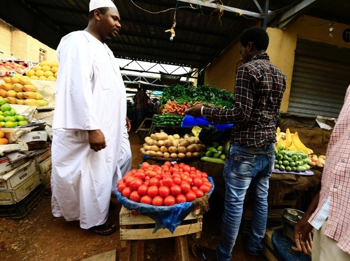 A man waits to buy food at a market in Khartoum July 28, 2016. REUTERS/Mohamed Nureldin Abdallah