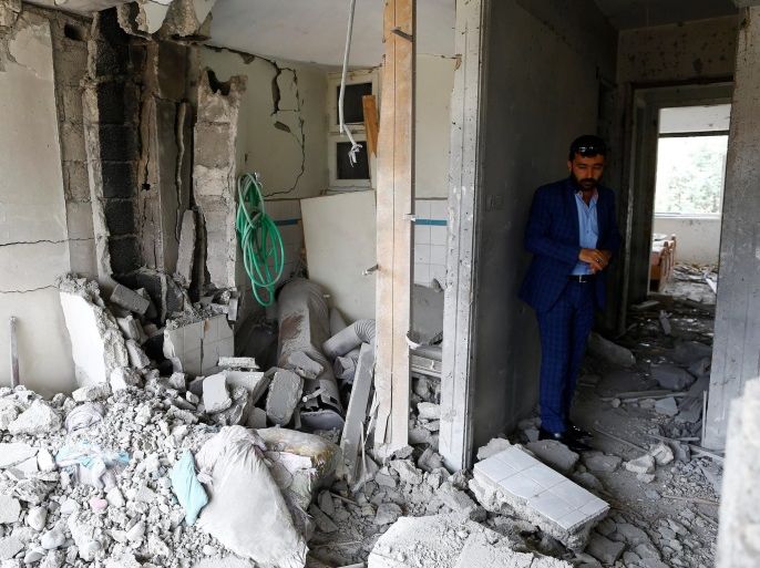 Omer Ciloglu stands inside his devastated house which was struck by a rocket from Syria in Turkey's southeastern border town of Kilis May 11, 2016. REUTERS/Osman Orsal
