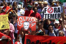 Demonstrators protest against President Michel Temer after the parade celebrating the country's Independence Day in Brasilia, Brazil, September 7, 2016. The signs (L-R) read, "Rights now", "Coup monger", "Out Temer." REUTERS/Adriano Machado