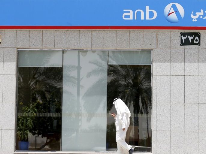 A Saudi man walks past ANB Bank in Riyadh, Saudi Arabia, April 25, 2016. REUTERS/Faisal Al Nasser