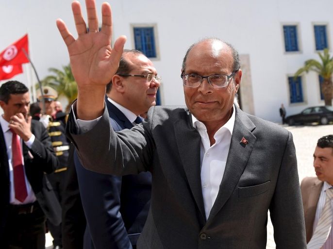 Former Tunisian president Moncef Marzouki arrives to take part in an anti-extremism march in Tunis March 29, 2015. World leaders joined tens of thousands of Tunisians on Sunday to march in solidarity against Islamist militants, a day after security forces killed members of a group blamed for a deadly museum attack. REUTERS/Emmanuel Dunand/Pool