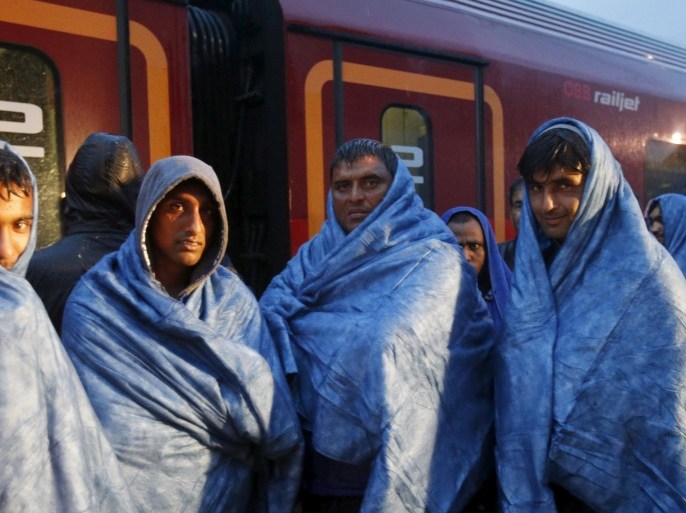 Migrants wait at the Austrian train station of Nickelsdorf to board trains to Germany, September 5, 2015. REUTERS/Heinz-Peter Bader/File Photo