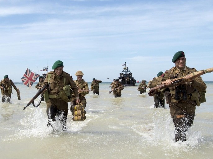 A handout image released by the British Ministry of Defence (MOD) shows people re-enacting marching onto the beach from a Landing Craft at the Normandy, France, 06 June 2014. More than 75,000 British Canadian and other Commonwealth Troops landed on the beaches of Normandy on 06 June 1944 alongside the United States and the Free French, in an Allied invasion of more than 130,000. Another 7,900 British troops were landed by Air. The invasion established a crucial second front in the Liberation of Europe from Nazi occupation, ultimately leading to victory for Allied Forces in 1945. EPA/JAMIE PETERS RLC / HANDOUT