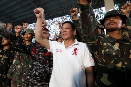 A handout photo made available by the Presidential Photographers Division (PPD) on 16 September 2016 shows Filipino President Rodrigo Duterte (C) and soldiers gesturing during his visit the Philippine Army Scout Rangers at their headquarters in the town of San Miguel, Philippines, 15 September 2016. The Senate Committee on Justice and Human Rights and Public Order headed by Senator Laila De Lima resume its hearing on 15 September on the extra judicial killings in relati