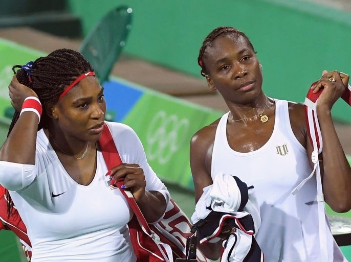 2016 Rio Olympics - Tennis - Preliminary - Women's Doubles First Round - Olympic Tennis Centre - Rio de Janeiro, Brazil - 07/08/2016. Serena Williams (USA) of USA and Venus Williams (USA) of USA leave after losing their match against Lucie Safarova (CZE) of Czech Republic and Barbora Strycova (CZE) of Czech Republic. REUTERS/Toby Melville FOR EDITORIAL USE ONLY. NOT FOR SALE FOR MARKETING OR ADVERTISING CAMPAIGNS.