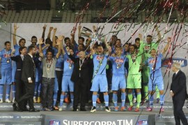 Napoli's players celebrate with the trophy after winning their Italian Super Cup match against Juventus at Al-Sadd Stadium, in Doha, December 22, 2014. REUTERS/Fadi Al-Assaad (QATAR - Tags: SPORT SOCCER)