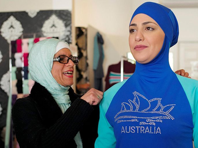 الموسوعة - Aheda Zanetti (L), designer of the Burkini swimsuit, adjusts one of the swimsuits on model Salwa Elrashid at her fashion store in Sydney, August 23, 2016. REUTERS/Jason Reed