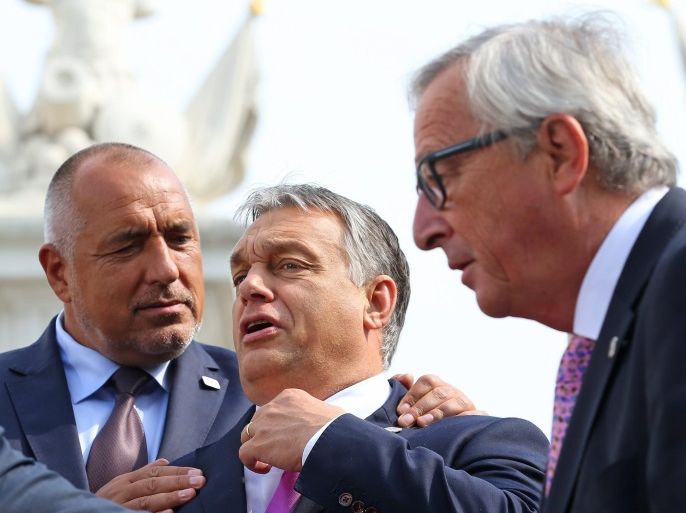 Bulgarian Prime Minister Boyko Borisov (L) and Hungarian Prime Minister Viktor Orban (C) joke around while European Commission President Jean-Claude Juncker (R) walks byafter a group photo being taken at the Bratislava Castle during the Bratislava EU summit, an informal meeting of the 27 heads of state or government, in Bratislava, Slovakia, 16 September 2016. European Union leaders meet to discuss a new strategy and future of the European Union after the recent Brexit