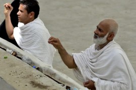 Two Muslim pilgrims perfrom the ritual known as 'the Stoning of the Devil,' in Mina near Mecca, Saudi Arabia, October 04 2014. Muslims worldwide are celebrating Eid al-Fitr commemorating Abraham's obedience to God through his attempted sacrifice of his son, which marks the end of Hajj, the annual pilgrimage when millions of Muslims travel to Mecca and the surrounding area to perform a series of religious duties, including the 'Stoning of the Devil.'