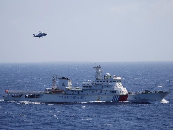 Chinese ship and helicopter are seen during a search and rescue exercise near Qilian Yu subgroup in the Paracel Islands, which is known in China as Xisha Islands, South China Sea, July 14, 2016. REUTERS/Stringer REUTERS ATTENTION EDITORS - THIS IMAGE WAS PROVIDED BY A THIRD PARTY. EDITORIAL USE ONLY. CHINA OUT. NO COMMERCIAL OR EDITORIAL SALES IN CHINA. TPX IMAGES OF THE DAY