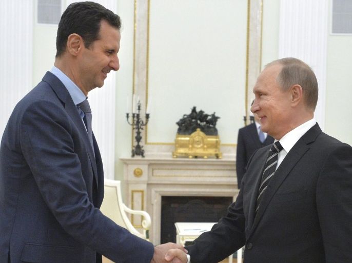 Russian President Vladimir Putin (R) shakes hands with Syrian President Bashar al-Assad during a meeting at the Kremlin in Moscow, Russia, October 20, 2015. Assad flew to Moscow on Tuesday evening to personally thank Putin for his military support, in a surprise visit that underlined how Russia has become a major player in the Middle East. Picture taken October 20, 2015. REUTERS/Alexei Druzhinin/RIA Novosti/Kremlin ATTENTION EDITORS - THIS IMAGE HAS BEEN SUPPLIED BY A T