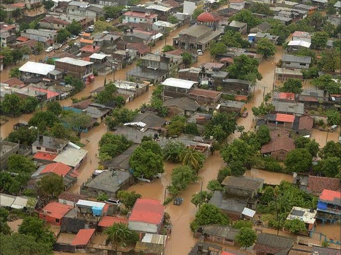 epa05526503 A handout photo made available by the Mexican Information Agency Quadratin on 06 September 2016 shows an aereal view of a zone affected by a flooding caused by heavy rains from hurricane 'Newton' in Benito Juarez, Mexico, 05 September 2016.