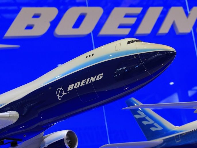 Models of Boeing 747 and 777 passenger planes are displayed at the Boeing booth as part of the China International Aviation & Aerospace Exhibition in Zhuhai in this file photo taken November 12, 2012. Boeing Co said it booked 1,203 net orders for planes and delivered 601 new jets in 2012, a performance that likely puts it ahead of rival Airbus for the prize of being the world's largest plane maker. REUTERS/Bobby Yip/Files (CHINA - Tags: TRANSPORT BUSINESS)