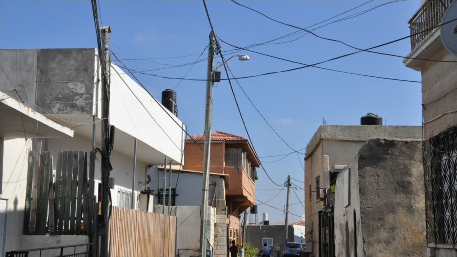 ‪قوانين البناء الإسرائيلية تشترط ربط المنازل بشبكة الكهرباء بالحصول على تراخيص البناء‬ (الجزيرة)