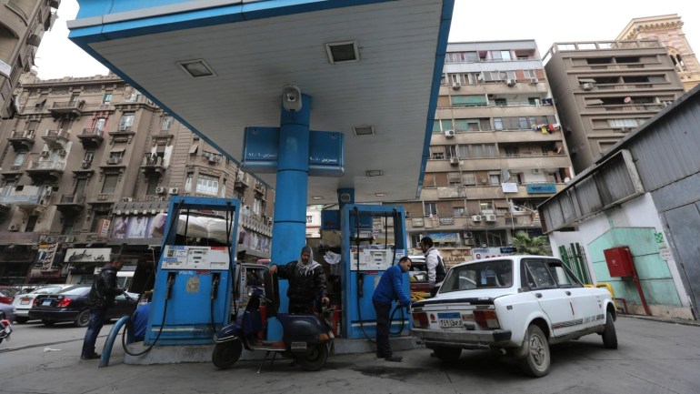 People are seen at a petrol station in Cairo, January 13, 2015. Reuters photographers from Mali to Mexico have shot a series of pictures of fuel stations. Whether it is plastic bottles by the roadside in Malaysia or a futuristic forecourt in Los Angeles, fuel stations help define our world. Oil prices steadied above $48 a barrel on Tuesday, recovering from earlier losses as the dollar weakened against the euro. Oil prices have dropped nearly 60 percent since peaking in June 2014 on ample global supplies from the U.S. shale oil boom and a decision by OPEC to keep its production quotas unchanged. REUTERS/Mohamed Abd El Ghany (EGYPT - Tags: TRANSPORT BUSINESS COMMODITIES ENERGY)ATTENTION EDITORS: PICTURE 15 OF 26 FOR WIDER IMAGE PACKAGE 'AT THE PUMP - THE WORLD FILLS UP' SEARCH 'WORLD FILLS UP' FOR ALL IMAGES
