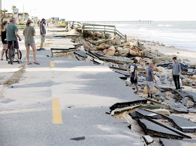 Beach goers check out damage left by Hurricane Mathew by washing away part of the historic State Road A1A in Flagler County, Florida, USA, 08 October 2016. Hurricane Matthew hit the Florida coast leaving four dead and thousands without power, media reported.