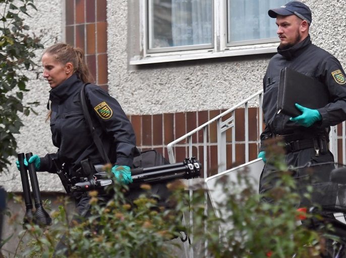 German police and crime scene investigators exit an appartment complex in the Pausdorf district of Leipzig, Germany, 10 October 2016. Fugitive terror-suspect Jaber al-Bakr was arrested in the night in Leipzig. The 22-year-old Syrian had been on the run since an anti-terrorist raid on 08 October, in Chemnitz. Several hundred grams of explosives were reportedly found during a search in the Chemnitz apartment where al-Bakr was staying.