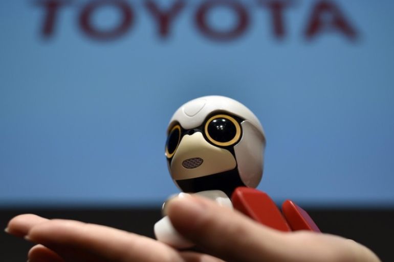 A picture made available 03 October 2016 shows a staff member presenting 'Kirobo Mini' robot during a press conference in Tokyo, Japan, 27 September 2016. The giant carmaker is to put on sale its communication compact robot Kirobo Mini across Japan in 2017 with presales organized at a price of 39,800 yen (around 350 euros). Kirobo mini is capable of having casual conversations, remember past events and react to user emotions while its small size allows the robot to be taken anywhere.