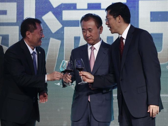 (L-R) Yu Hong Chen of the Chinese Football Association, Wang Jianlin, Chairman of China's Wanda Group and Gaungxi autonomous region Vice-Chairman Hu Zhuo offer each other a toast during ceremonies to mark a signing ceremony and press conference for the 'China Cup' international football tournament, at the Sofitel Hotel in Beijing, China, 13 July 2016. According to a press release from Wanda Group, The Chinese Football Association (CFA), the Asian Football Confederati