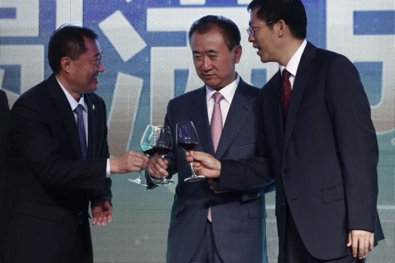 (L-R) Yu Hong Chen of the Chinese Football Association, Wang Jianlin, Chairman of China's Wanda Group and Gaungxi autonomous region Vice-Chairman Hu Zhuo offer each other a toast during ceremonies to mark a signing ceremony and press conference for the 'China Cup' international football tournament, at the Sofitel Hotel in Beijing, China, 13 July 2016. According to a press release from Wanda Group, The Chinese Football Association (CFA), the Asian Football Confederati