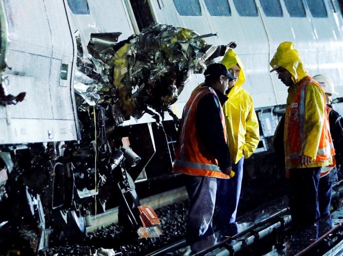Emergency responders work near a train that sits derailed near the community of New Hyde Park on Long Island in New York, U.S, October 9, 2016. REUTERS/Eduardo Munoz