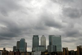 Storm clouds are seen above the Canary Wharf financial district in London, Britain, August 3, 2010. REUTERS/Greg Bos/File Photo