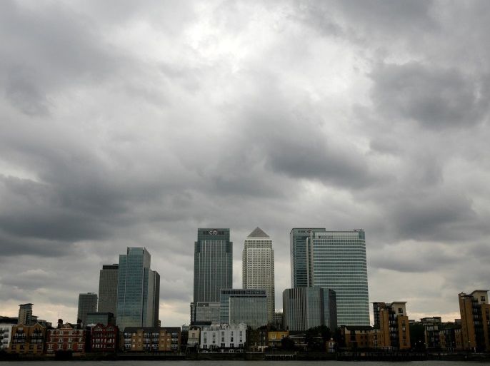 Storm clouds are seen above the Canary Wharf financial district in London, Britain, August 3, 2010. REUTERS/Greg Bos/File Photo