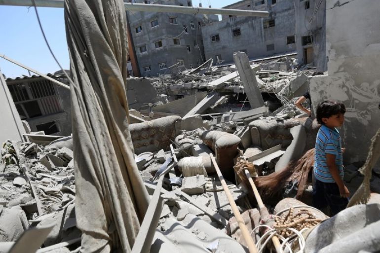 A young Palestinian boy inspects the rubble of a destroyed house after an Israeli airstrike, in Jabaliya refugee camp, northern Gaza Strip, 25 August 2014. Six Palestinians were killed in the Gaza Strip on 25 August in fresh Israeli air raids, the Health Ministry in the coastal territory said.