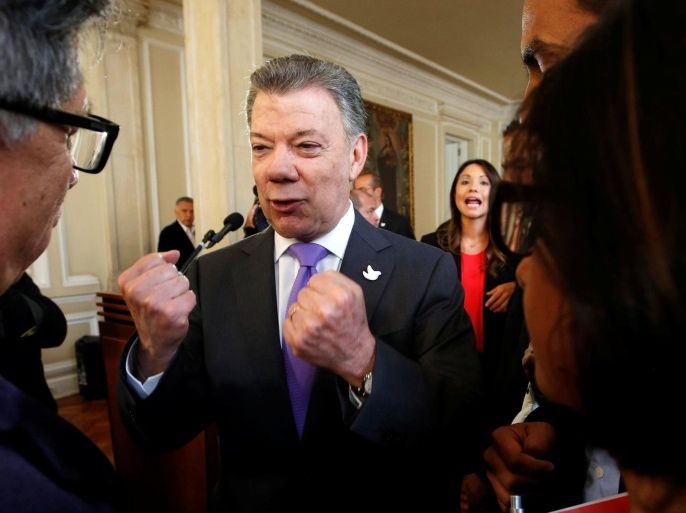 Colombia's President Juan Manuel Santos (2nd L) gestures while talking to people who worked for the peace accord to be approved in the recent referendum, after winning the Nobel Peace Prize, at Narino Palace in Bogota, Colombia, October 7, 2016. REUTERS/John Vizcaino
