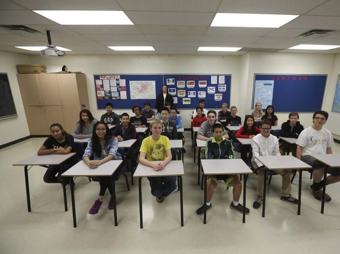 Teacher Kathy Stauch's 9th Grade French-immersion geography class pose for a picture at Lisgar Collegiate Institute in Ottawa, Canada, September 24, 2015. Founded in 1843, Lisgar Collegiate is a historic public secondary school in downtown Ottawa a few blocks from Parliament Hill. Nearly three years after Taliban gunmen shot Pakistani schoolgirl Malala Yousafzai, the teenage activist last week urged world leaders gathered in New York to help millions more children go to school. World Teachers' Day falls on 5 October, a Unesco initiative highlighting the work of educators struggling to teach children amid intimidation in Pakistan, conflict in Syria or poverty in Vietnam. Even so, there have been some improvements: the number of children not attending primary school has plummeted to an estimated 57 million worldwide in 2015, the U.N. says, down from 100 million 15 years ago. Reuters photographers have documented learning around the world, from well-resourced schools to pupils crammed into corridors in the Philippines, on boats in Brazil or in crowded classrooms in Burundi. REUTERS/Chris WattiePICTURE 2 OF 47 FOR WIDER IMAGE STORY "SCHOOLS AROUND THE WORLD"SEARCH "EDUCATORS SCHOOLS" FOR ALL IMAGES